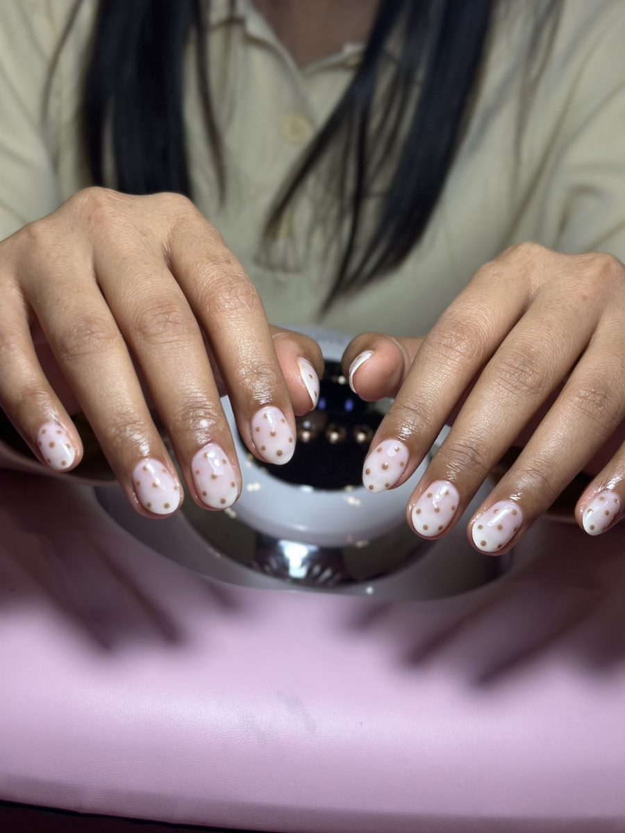 Milky white nails with gold dots