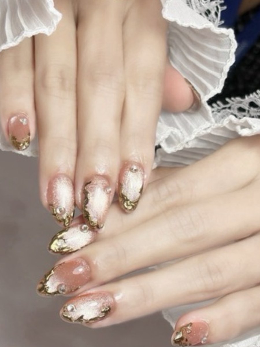 Gel nail art with gold accents